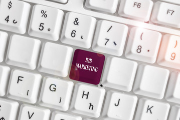 Text sign showing B2B Marketing. Business photo text Partnership Companies Supply Chain Merger Leads Resell White pc keyboard with empty note paper above white background key copy space