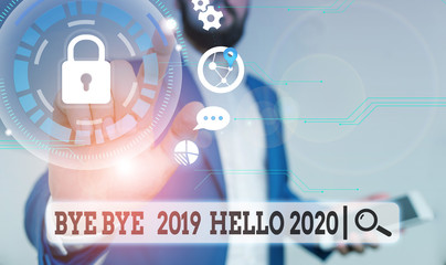 Text sign showing Bye Bye 2019 Hello 2020. Business photo text Starting new year Motivational message 2019 is over Male human wear formal work suit presenting presentation using smart device © A