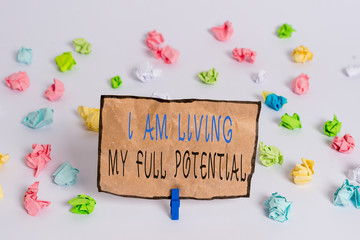 Text sign showing I Am Living My Full Potential. Business photo text Embracing opportunities using skills abilities Colored crumpled papers empty reminder white floor background clothespin
