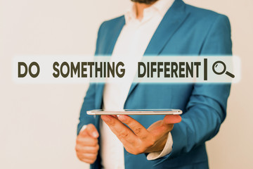 Text sign showing Do Something Different. Business photo showcasing be unique Think outside of the box Have some fun Man in the blue suite and white shirt holds mobile phone in the hand