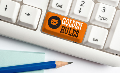 Conceptual hand writing showing Golden Rules. Concept meaning basic principle that should always follow to ensure success White pc keyboard with note paper above the white background