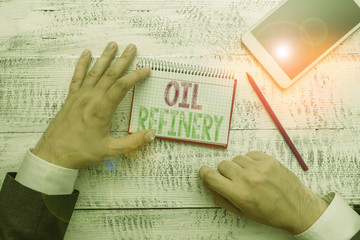 Conceptual hand writing showing Oil Refinery. Concept meaning industrial process of converting...