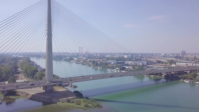 Establishing slow descending aerial shot of Sava river and Ada bridge in Belgrade