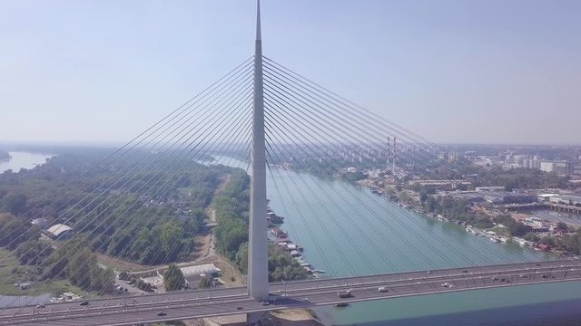 Slow revealing 4k aerial shot of Ada bridge in Belgrade, river and lake