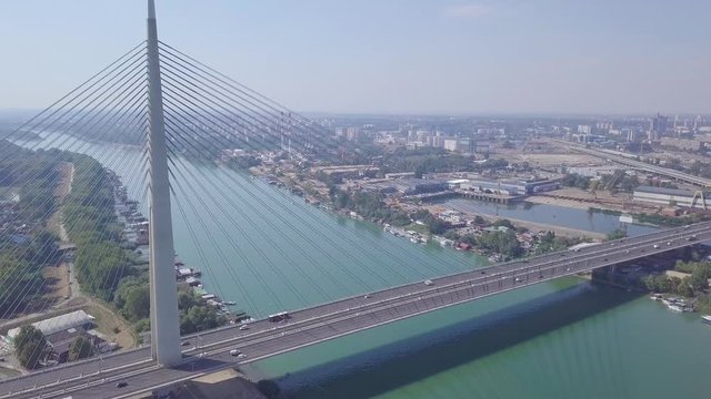Slow descending aerial shot of Ada bridge in Belgrade and Sava lake