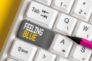 Conceptual hand writing showing Feeling Blue. Concept meaning Feeling of desperation because of...