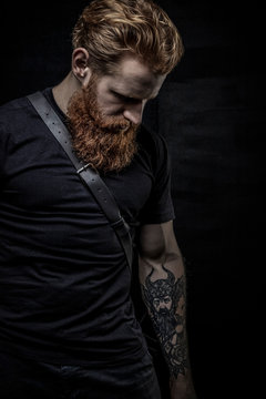 Red-haired urban fantasy man with tattoos