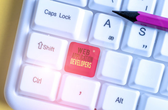 Text sign showing Web Application Developers. Business photo text Internet programming experts Technology software White pc keyboard with empty note paper above white background key copy space