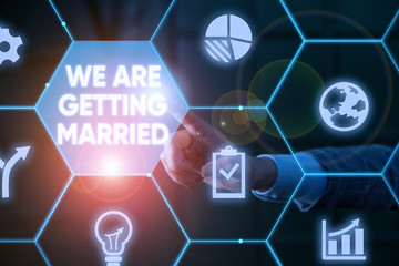 Writing note showing We Are Getting Married. Business concept for Engagement Wedding preparation Loving couple Male human wear formal suit presenting using smart device