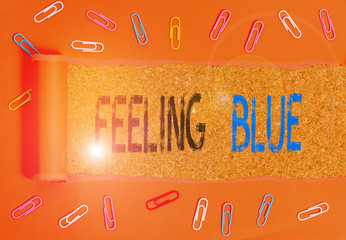 Writing note showing Feeling Blue. Business concept for Feeling of desperation because of sadness...