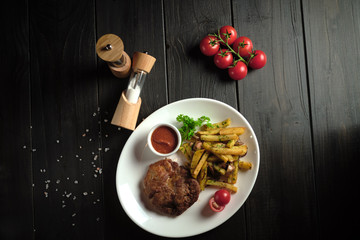 Meat medallion and french fries . catering menu