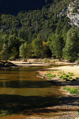  Merced River in Yosemite Valley. Beyond the glacial moraine at the western end of the valley the river flows through the steep Merced River Canyon.