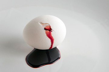 rejection of animal food: blood flows from a cracked white egg, short focus