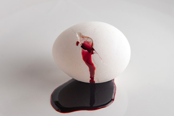 rejection of animal food: blood flows from a cracked white egg, short focus
