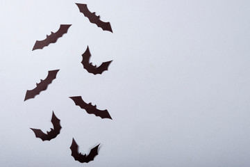 Halloween and decoration concept, Black paper bats flying over gray background.