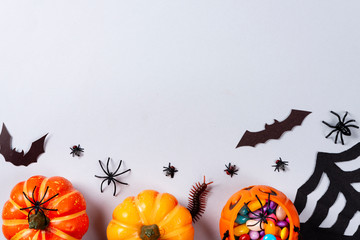 Halloween and decoration concept, Pumpkins, web, bats, spiders, centipede and flies on gray...