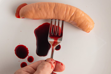 bloody food concept: bleeding sausage