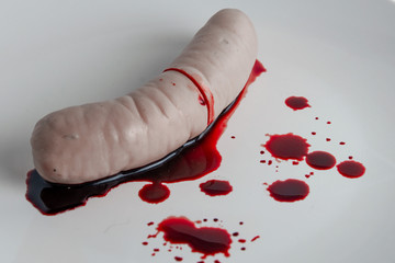 refusal to eat animal meat, concept: bleeding sausage on a white plate, blood splatter, short focus