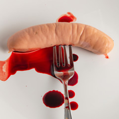 refusal to eat animal meat, concept: bleeding sausage on a white plate, blood splatter, short focus
