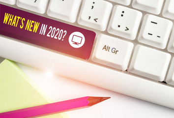 Writing note showing What S New In 2020 Question. Business concept for Expectation and Surprises for the coming Year White pc keyboard with note paper above the white background