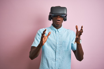 Young african american man playing virtual reality game using goggles
