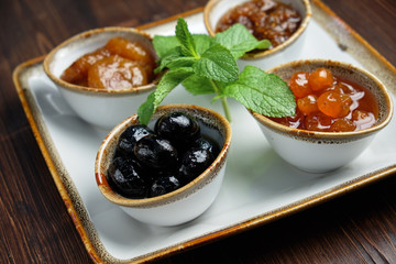 sauces in bowls on a dark wooden background. menu for catering