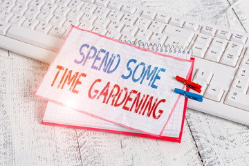 Word writing text Spend Some Time Gardening. Business photo showcasing Relax planting flowers fruits vegetables Natural notebook paper reminder clothespin pinned sheet white keyboard light wooden