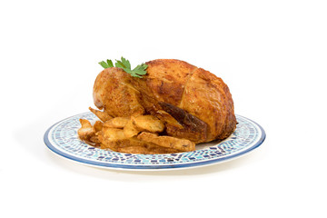 grocery store BBQ chicken and potato wedges on a blue plate isolated on white