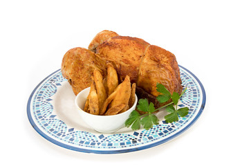 grocery store BBQ chicken and potato wedges in a bowl on a blue plate isolated on white