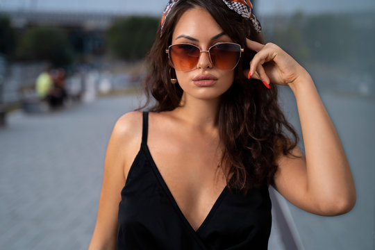 Closeup sensual curly hair girl with sunglasses outdoors portrait 