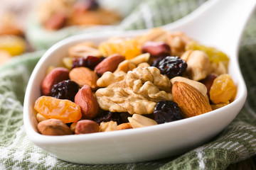 Healthy trail mix snack made of nuts (walnut, almond, peanut) and dried fruits (raisin, sultana) on...