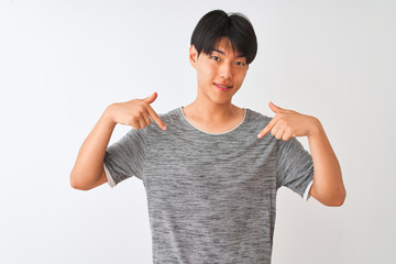 Young chinese man wearing casual t-shirt standing over isolated white background looking confident...