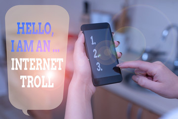 Writing note showing Hello I Am An Internet Troll. Business concept for Social media troubles discussions arguments woman using smartphone and technological devices inside the home