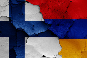 flags of Finland and Armenia painted on cracked wall