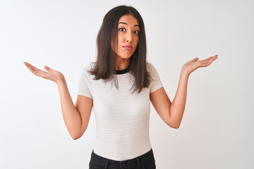 Young beautiful chinese woman wearing casual t-shirt standing over isolated white background...