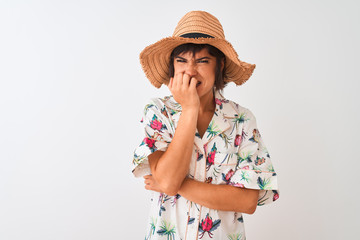 Beautiful woman on vacation wearing summer shirt and hat over isolated white background looking stressed and nervous with hands on mouth biting nails. Anxiety problem.