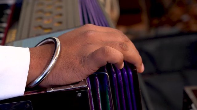 A sikh playing Harmonium during kirtan  of Guru Granth Sahib . Playing Harmonium a classical Musical instrument.