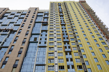 Construction of a new residential complex.Tall house. Buildings made of glass and concrete.