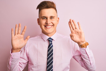 Young handsome businessman wearing shirt and tie standing over isolated pink background showing and...