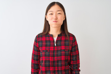 Young chinese woman wearing casual jacket standing over isolated white background puffing cheeks with funny face. Mouth inflated with air, crazy expression.