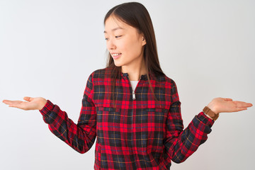 Young chinese woman wearing casual jacket standing over isolated white background smiling showing both hands open palms, presenting and advertising comparison and balance