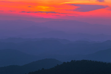 Wide natural background blurred by the bright sunlight above the mountains during the reversal of the horizon, beautiful twilight light, cold wind blowing through, fresh air