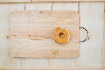 Wooden board with the decoration of donuts