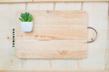 Wooden board and decorated with a mini plant pot