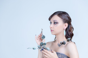 Fashion Brunette Model Portrait. Hairstyle. Professional creative Makeup. False Eyelashes.High fashion look close up beauty portrait of model with bright,shiny makeup with perfect clean skin