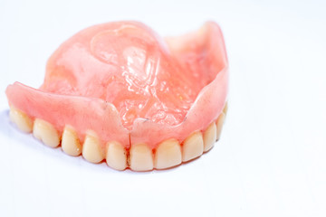 Old denture on a white background.