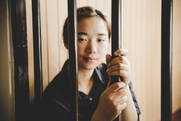 beautiful young girl behind the bars