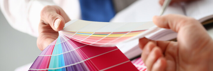 Employee refueling cartridge service holds magnifying glass in hand. Color print of pantone...