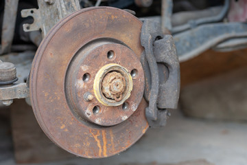 old rust brake disk repairing. checking brakes at transportation.