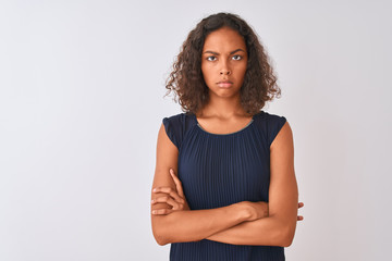 Young brazilian woman wearing blue dress standing over isolated white background skeptic and...